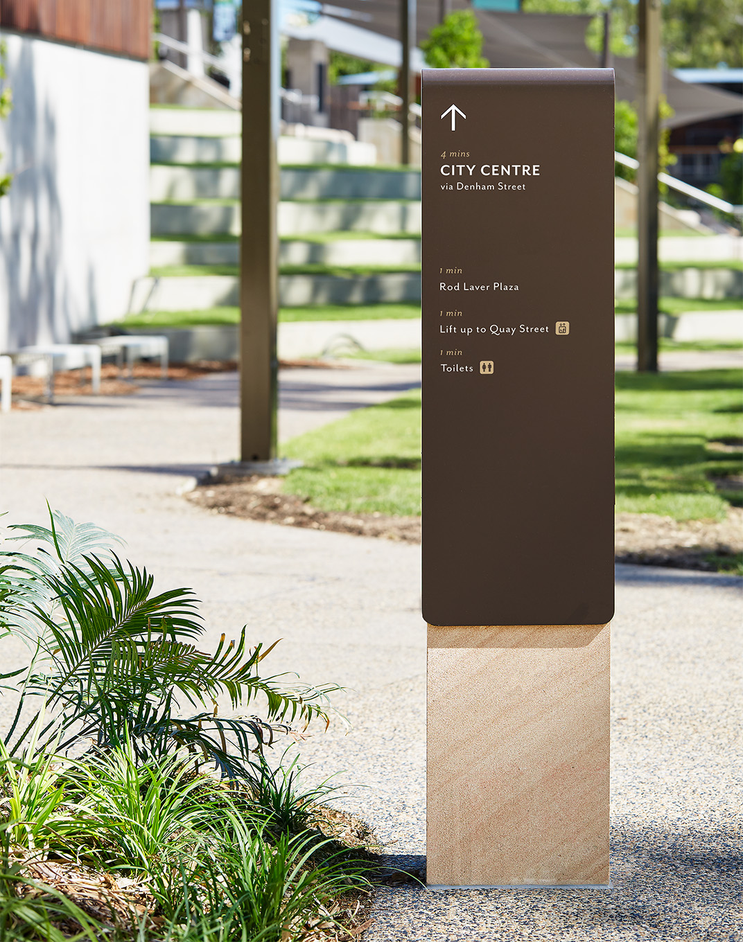 The wayfinding material palette complements the landscape design