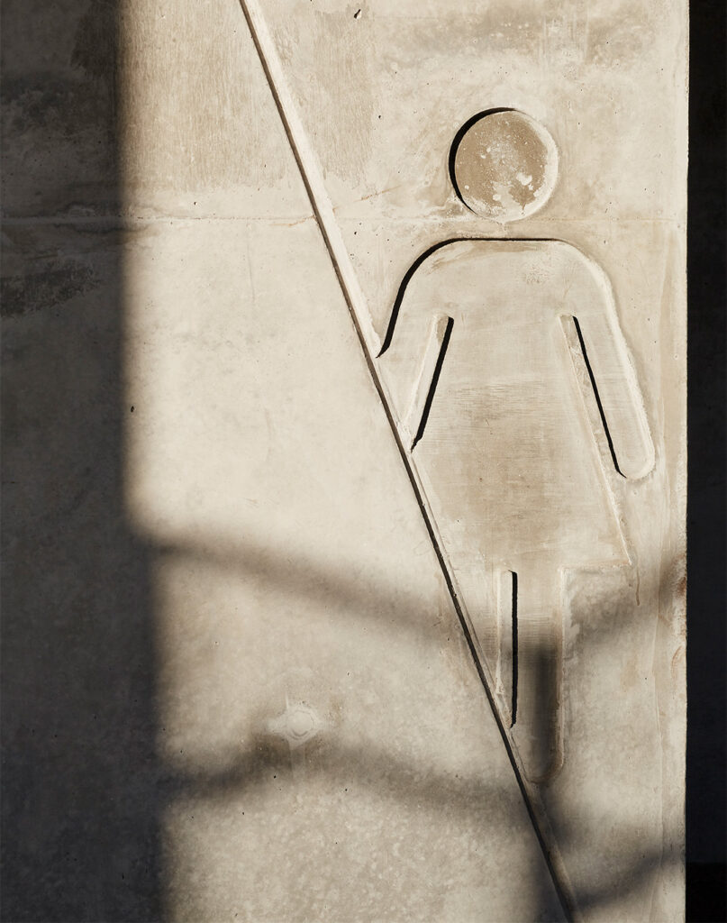 Integrated toilet wayfinding cast into concrete