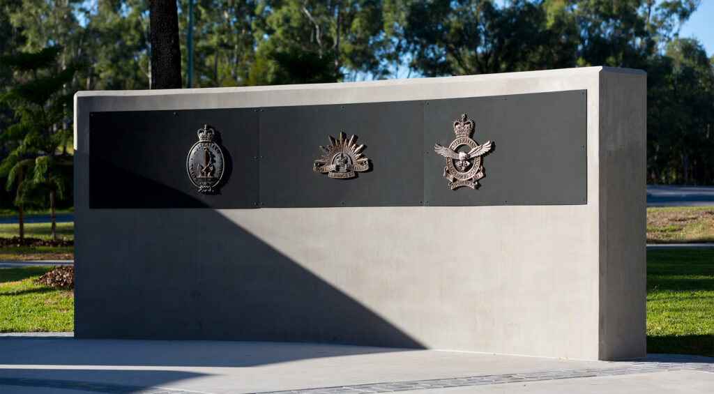Bronze emblems, etched glass, and formed lettering create a layered and tactile connection to history