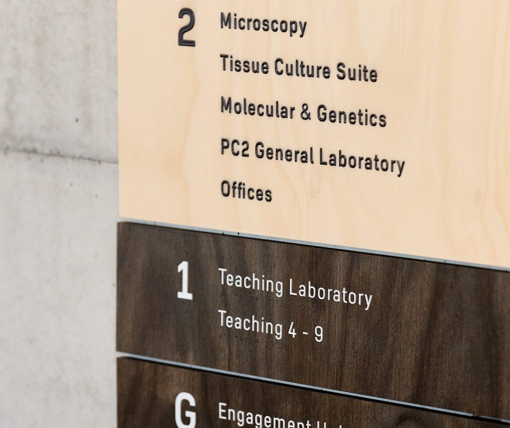 A braille and tactile detail shot of the lift directory signage.
